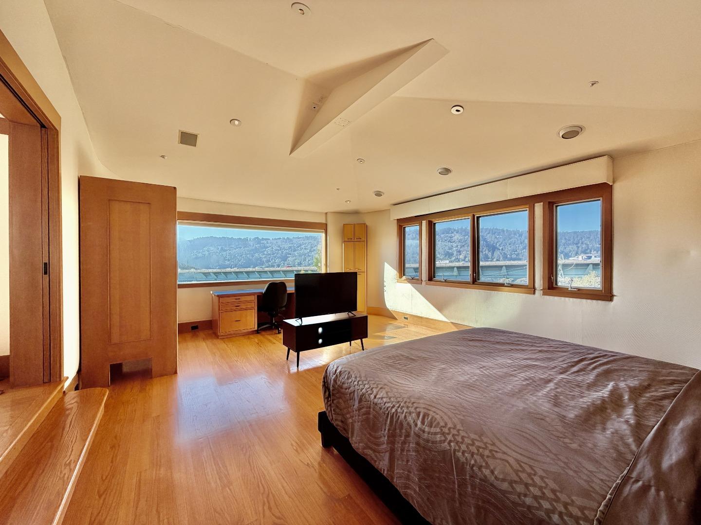 63 Berryessa Way Hillsborough, CA 94010 - Photo 8 of 39 a spacious bedroom with a bed and wooden floor