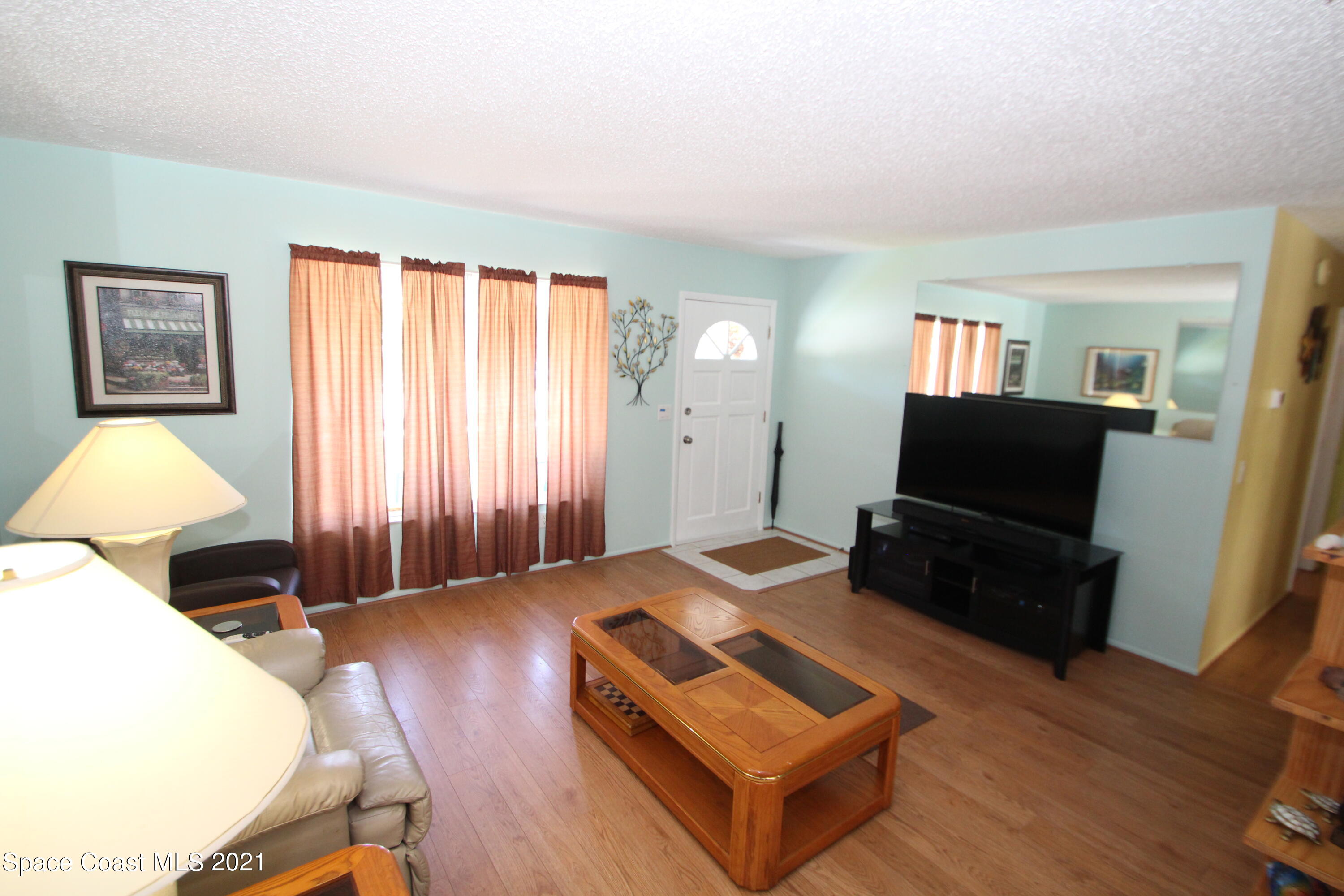 1398 Creel Road Northeast Palm Bay, FL 32905 - Photo 12 of 37 a living room with furniture and a flat screen tv