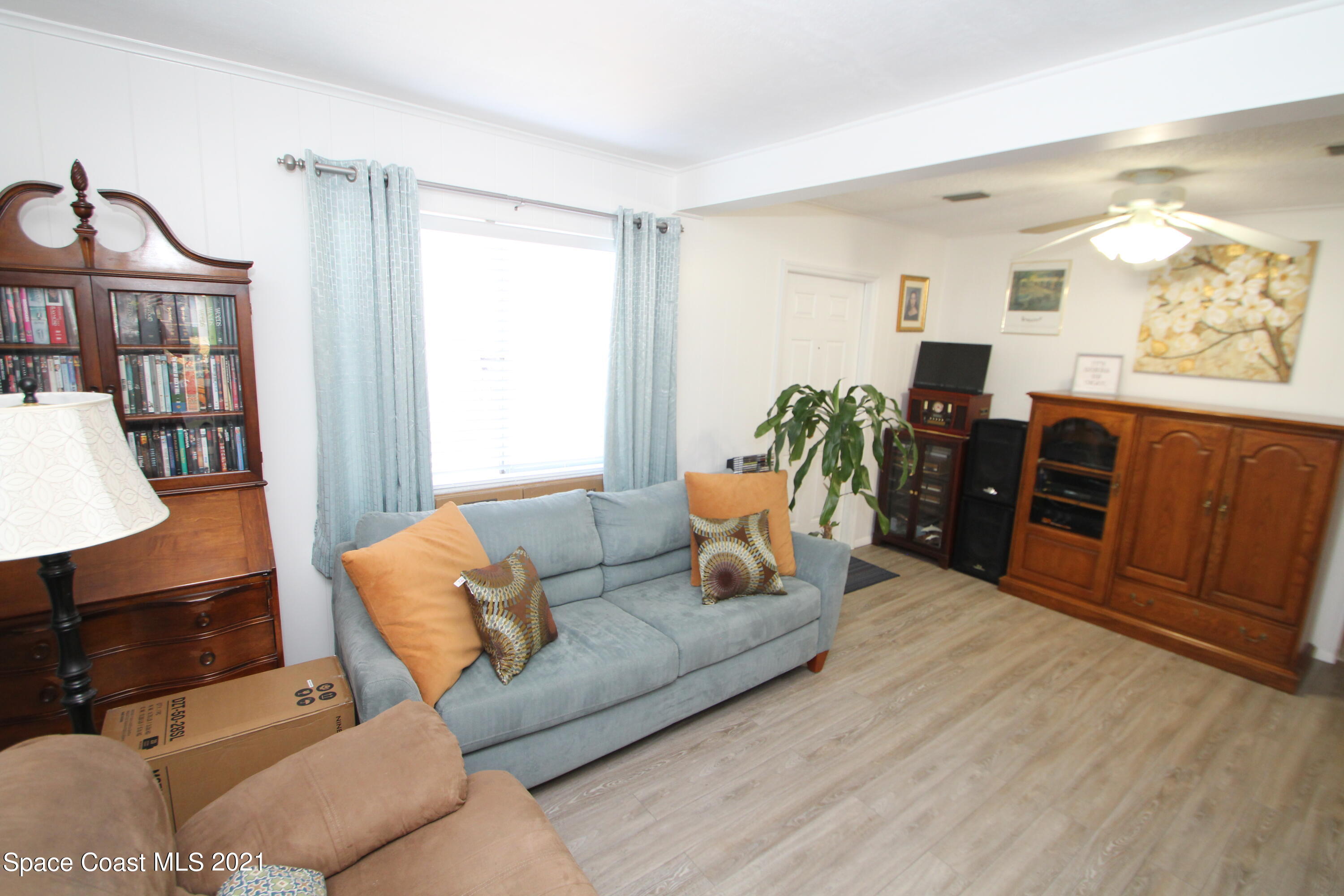 1398 Creel Road Northeast Palm Bay, FL 32905 - Photo 14 of 37 a living room with furniture and wooden floor