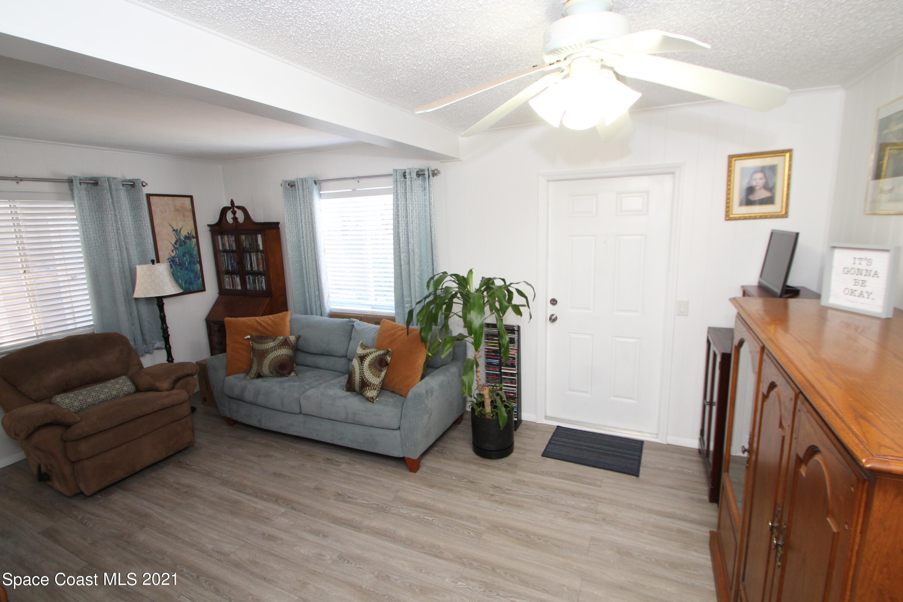 1398 Creel Road Northeast Palm Bay, FL 32905 - Photo 15 of 37 a living room with furniture and a wooden floor