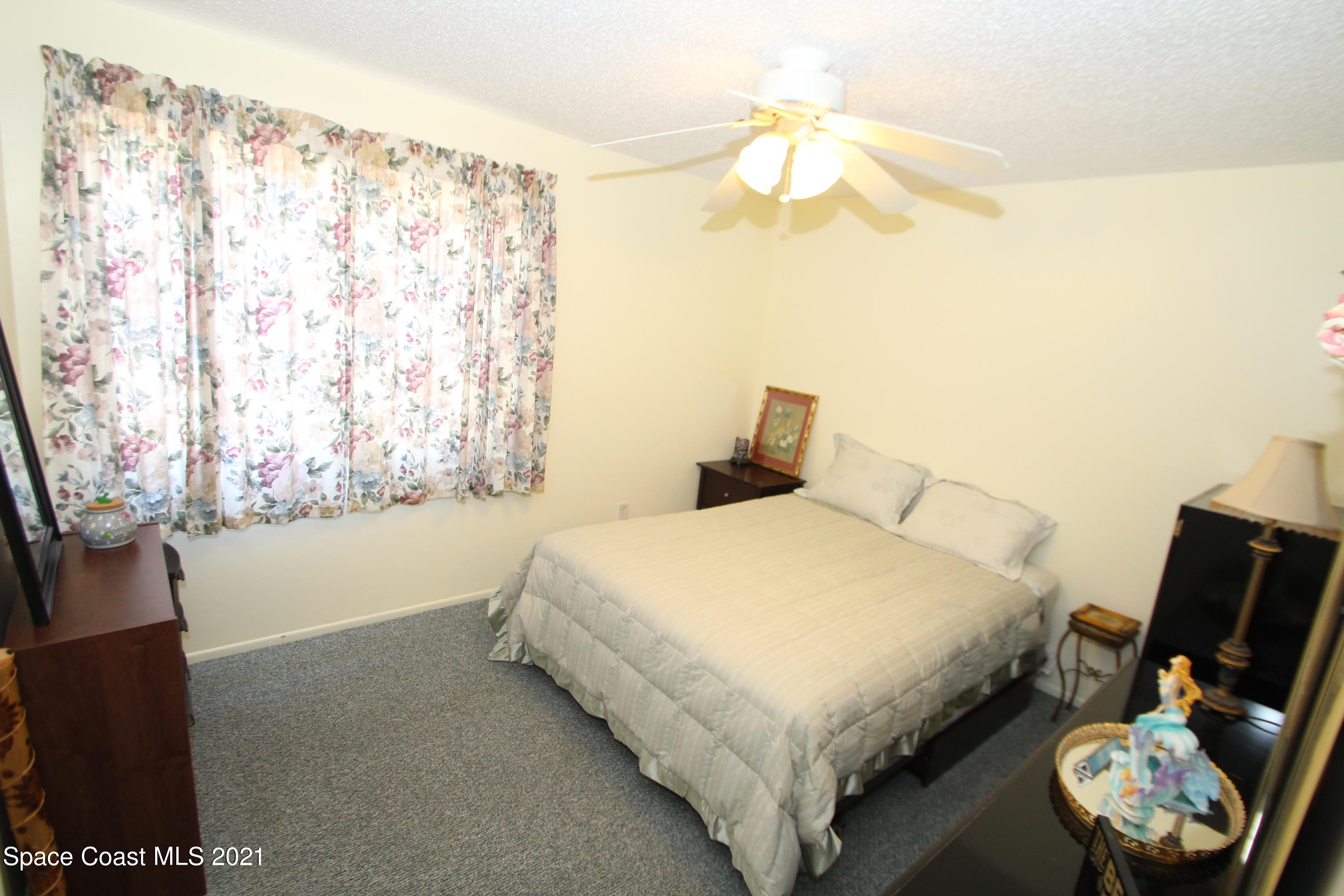 1398 Creel Road Northeast Palm Bay, FL 32905 - Photo 18 of 37 a bedroom with a bed and a tv