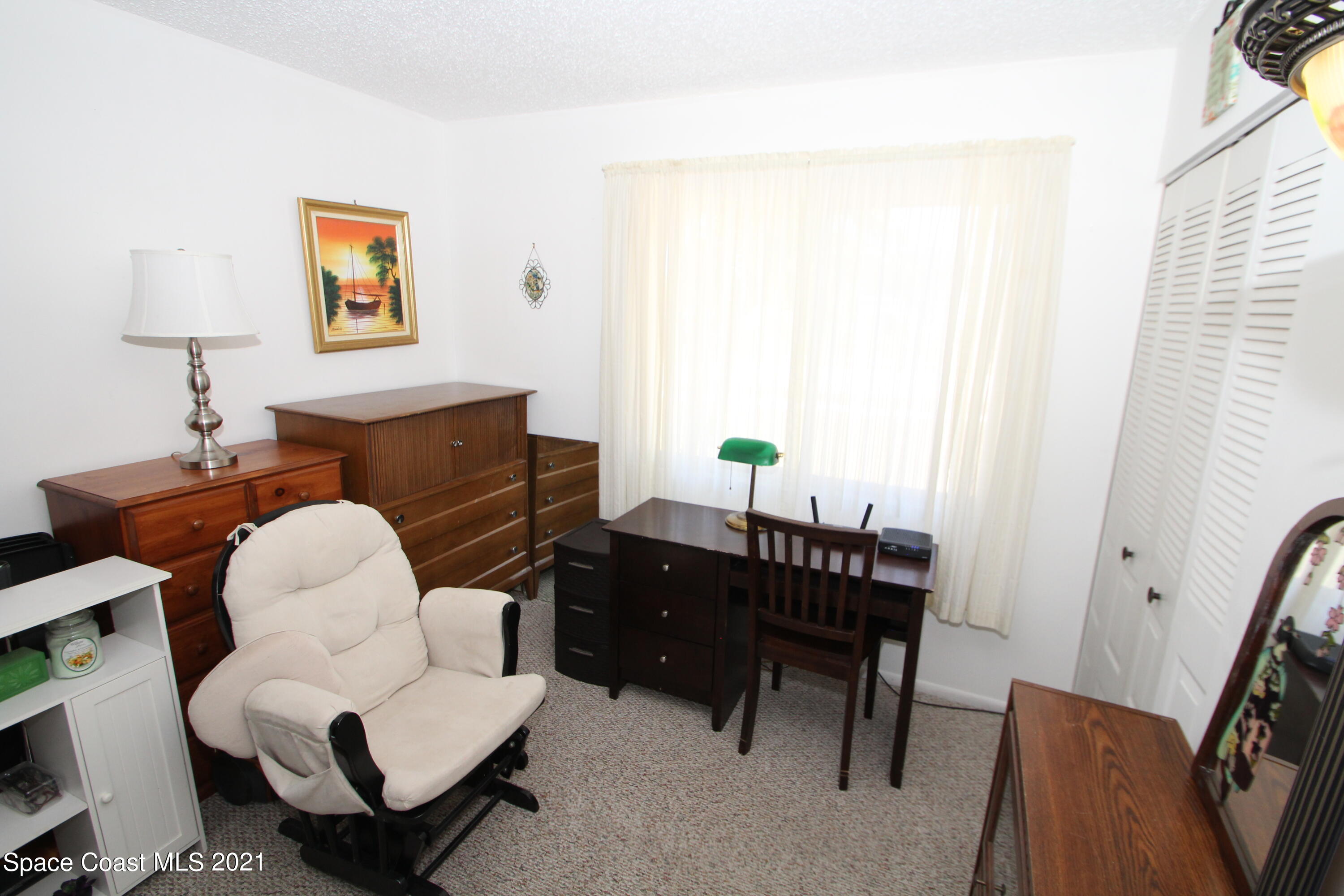 1398 Creel Road Northeast Palm Bay, FL 32905 - Photo 19 of 37 a living room with furniture and a window