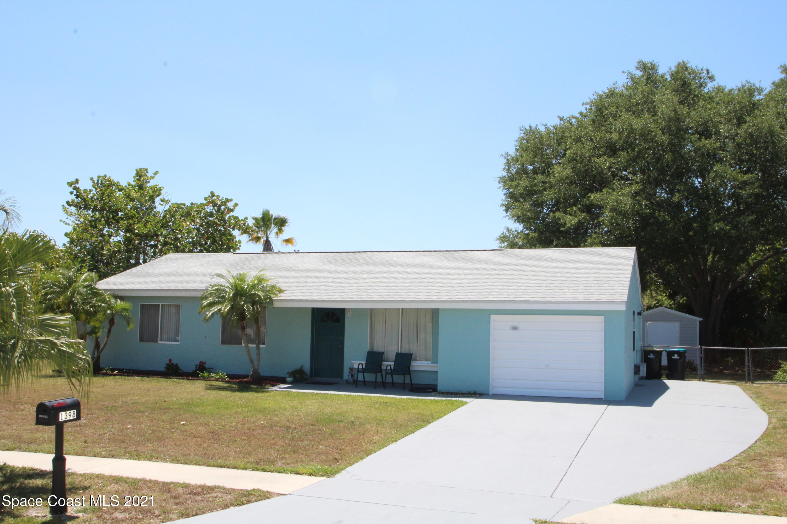 1398 Creel Road Northeast Palm Bay, FL 32905 - Photo 3 of 37 a front view of a house with a yard