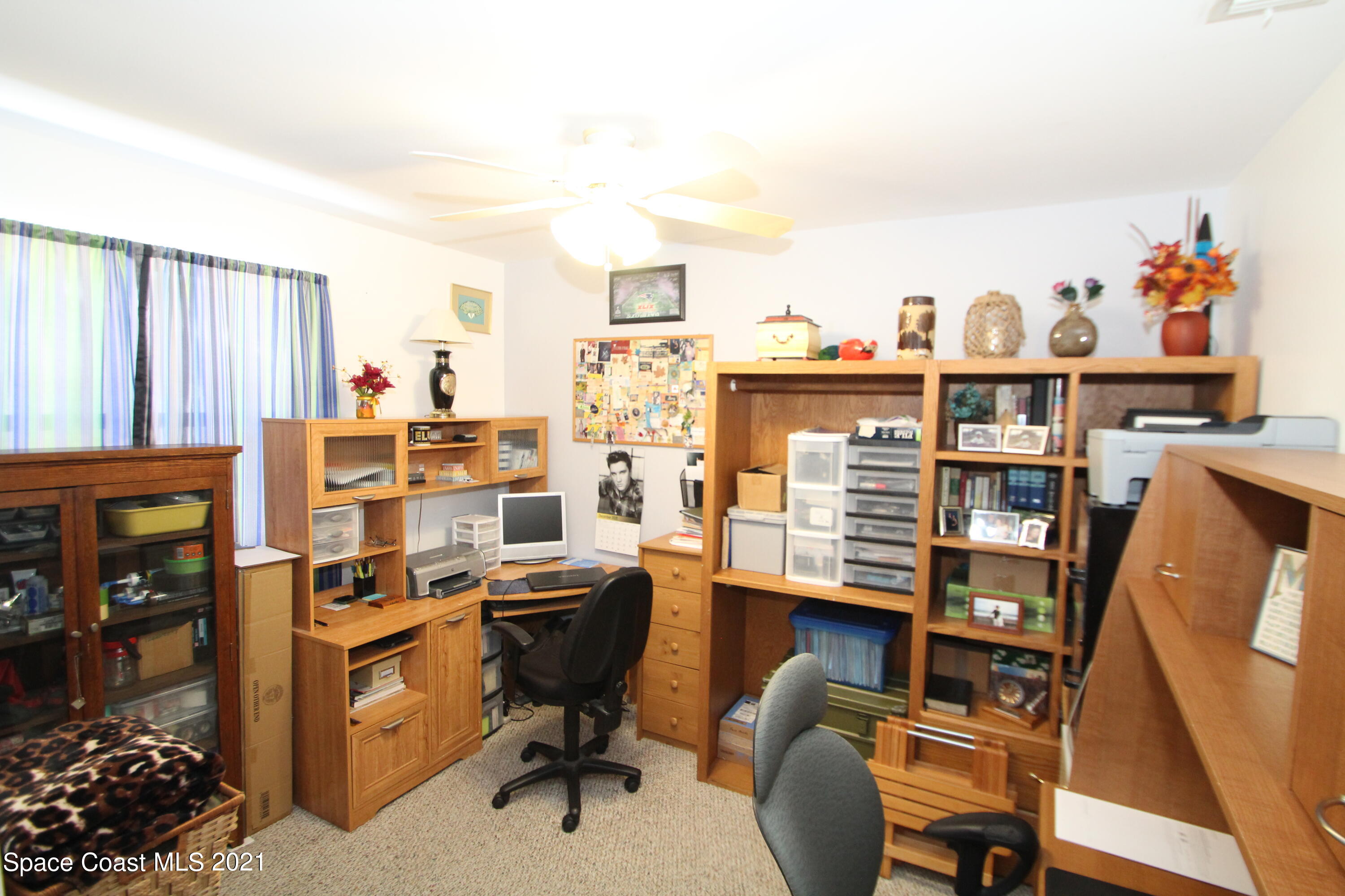 1398 Creel Road Northeast Palm Bay, FL 32905 - Photo 21 of 37 a view of a workspace with furniture and a window