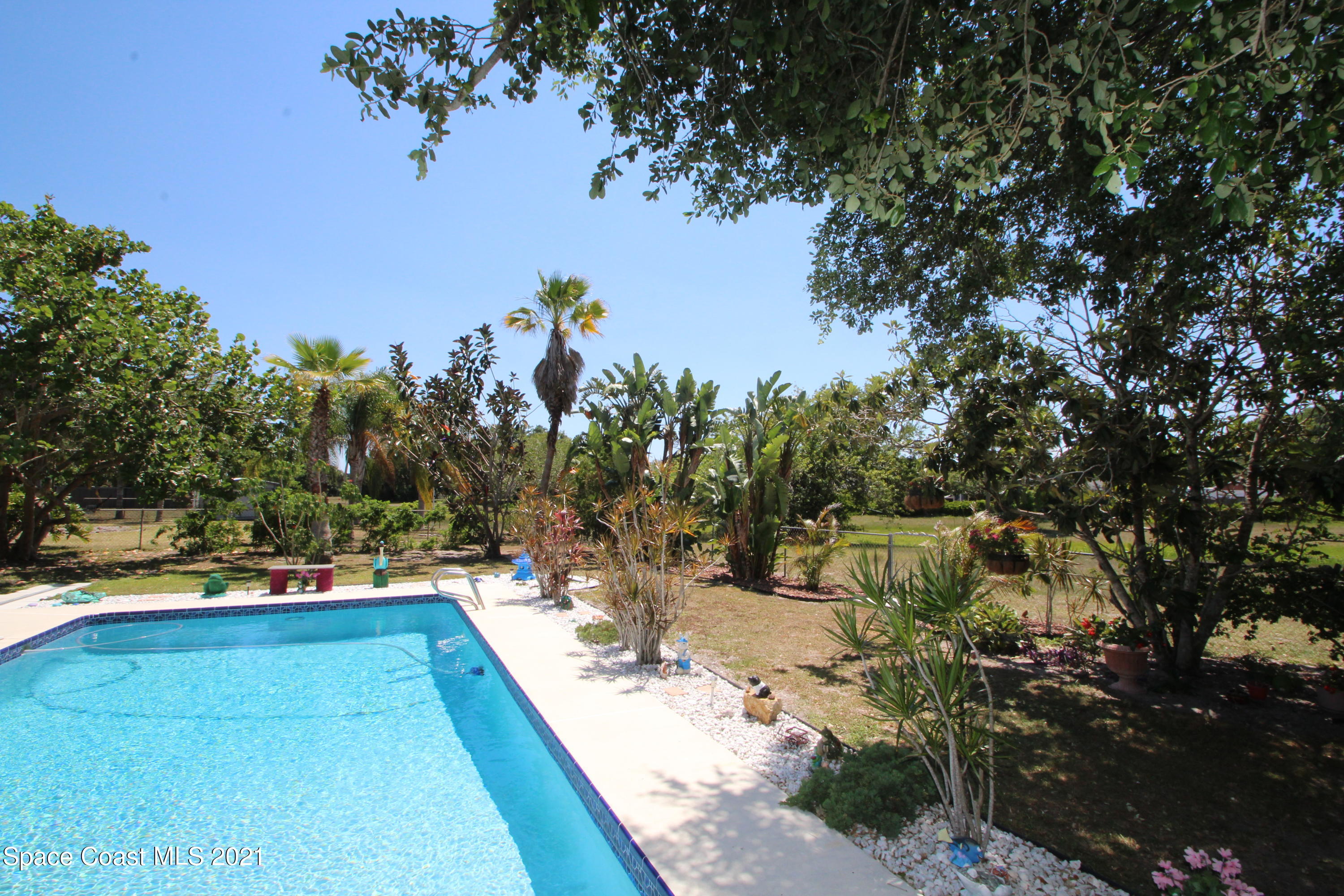1398 Creel Road Northeast Palm Bay, FL 32905 - Photo 27 of 37 a view of a yard with swimming pool