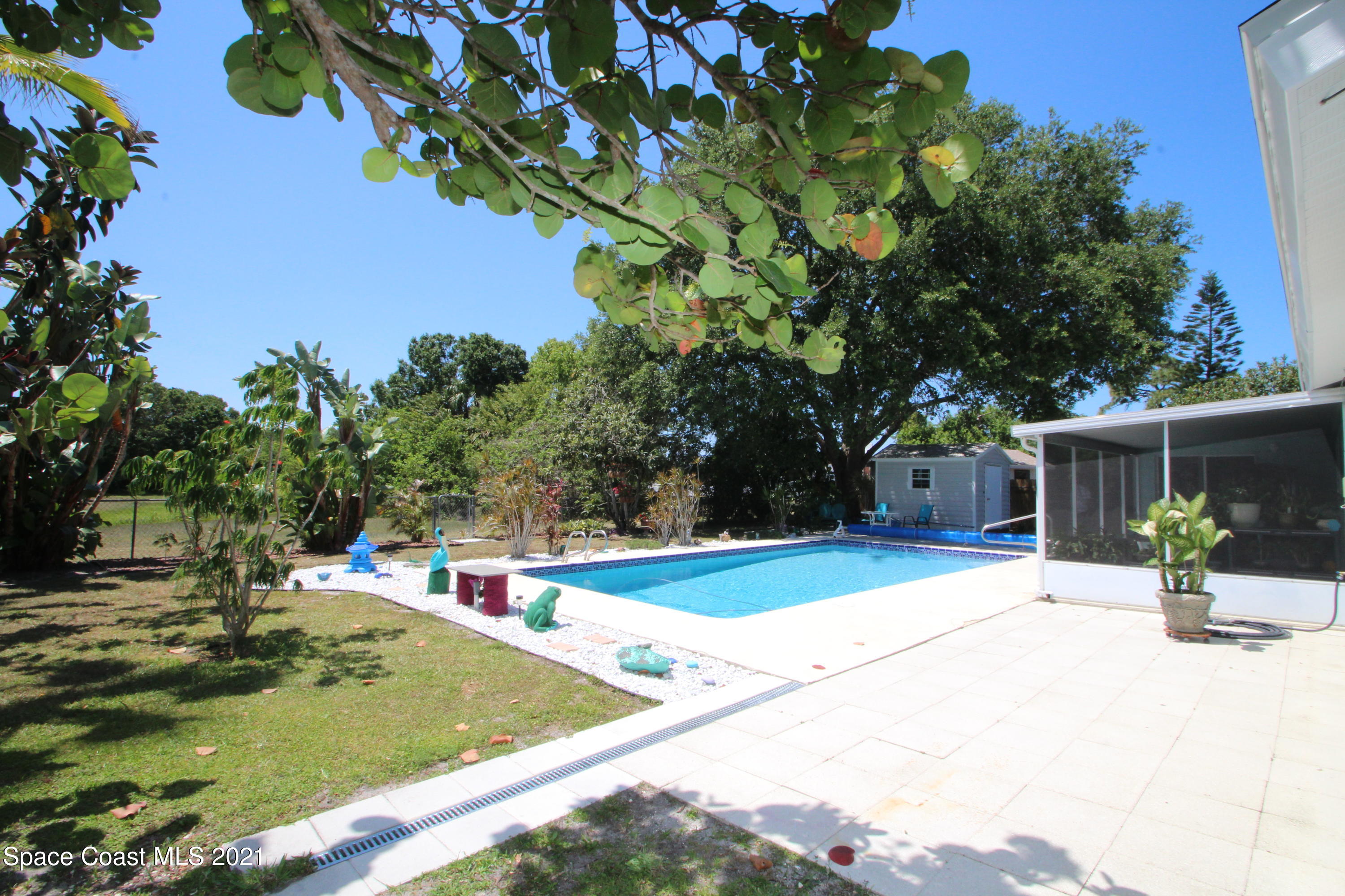 1398 Creel Road Northeast Palm Bay, FL 32905 - Photo 29 of 37 a view of a pool with a house