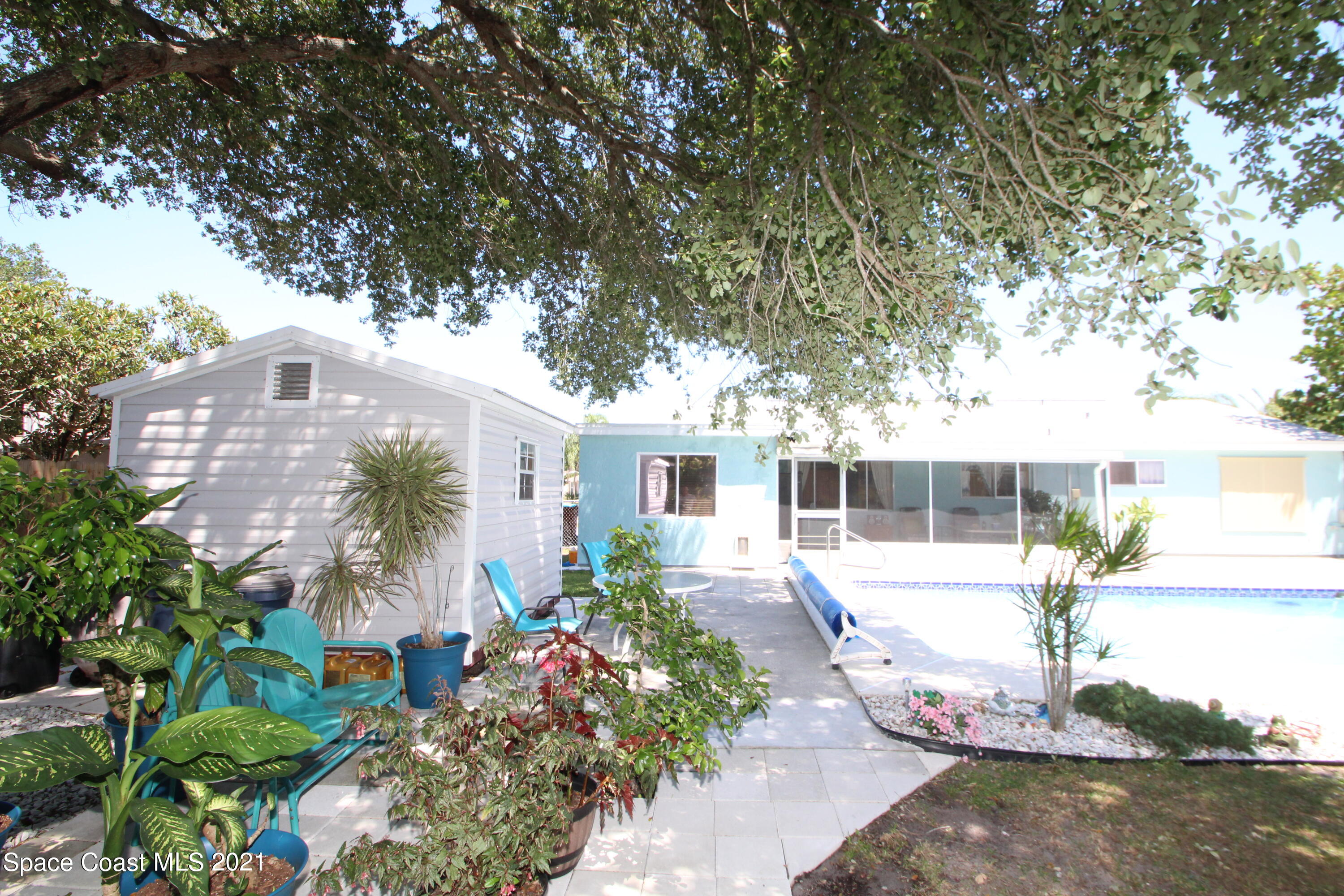 1398 Creel Road Northeast Palm Bay, FL 32905 - Photo 30 of 37 a front view of a house with garden