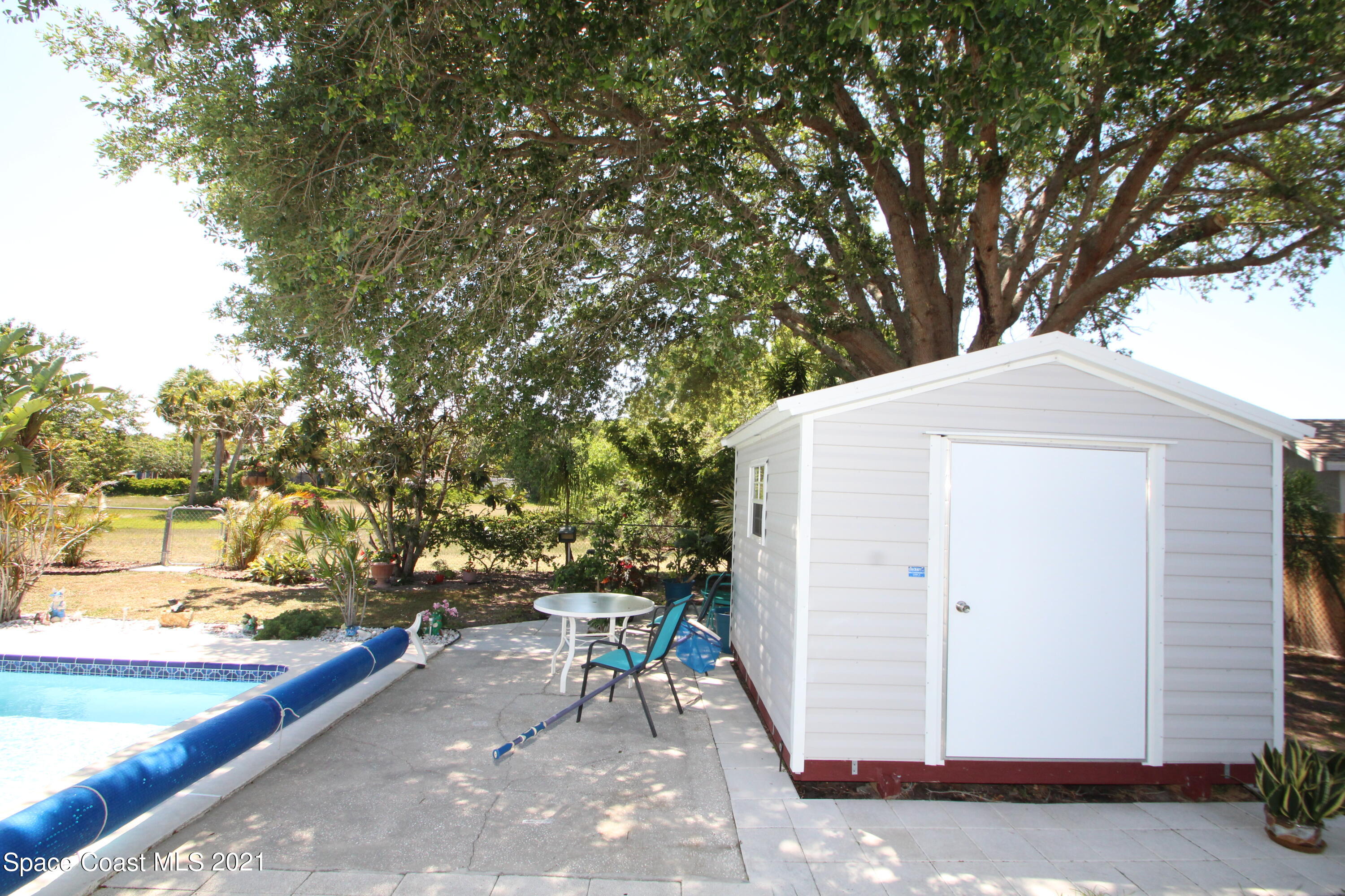 1398 Creel Road Northeast Palm Bay, FL 32905 - Photo 32 of 37 a view of a roof deck with table and chairs and wooden fence
