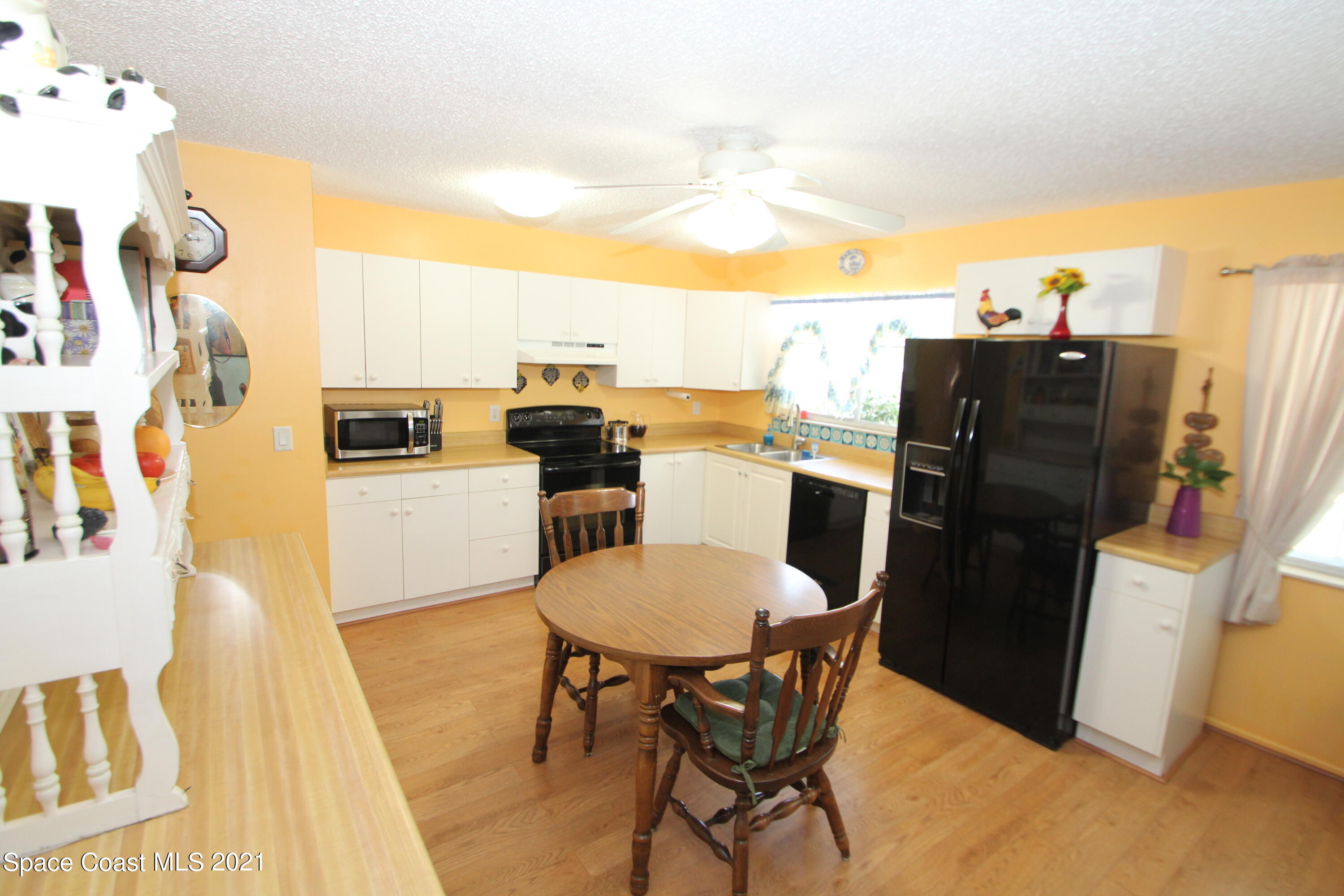 1398 Creel Road Northeast Palm Bay, FL 32905 - Photo 5 of 37 a view of a dining room with furniture and a kitchen