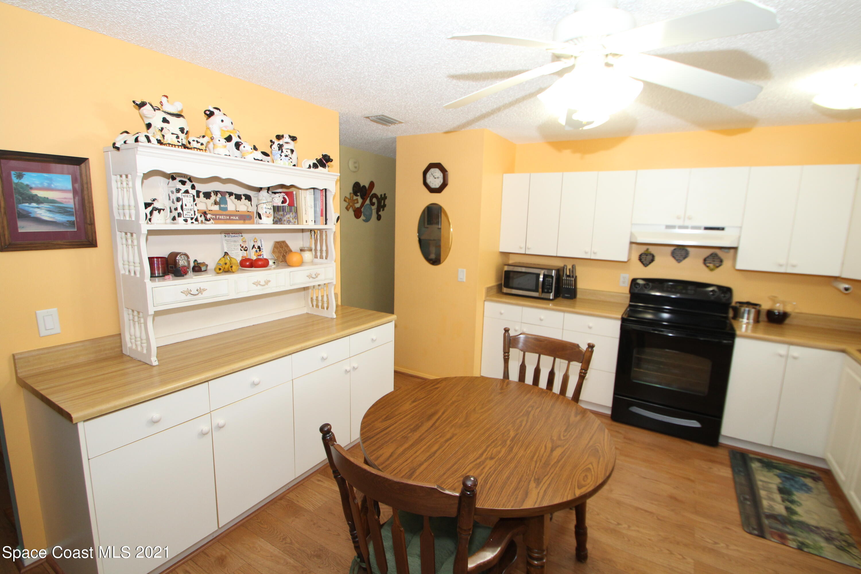 1398 Creel Road Northeast Palm Bay, FL 32905 - Photo 6 of 37 a very nice looking room with a dining table chairs with wooden floor