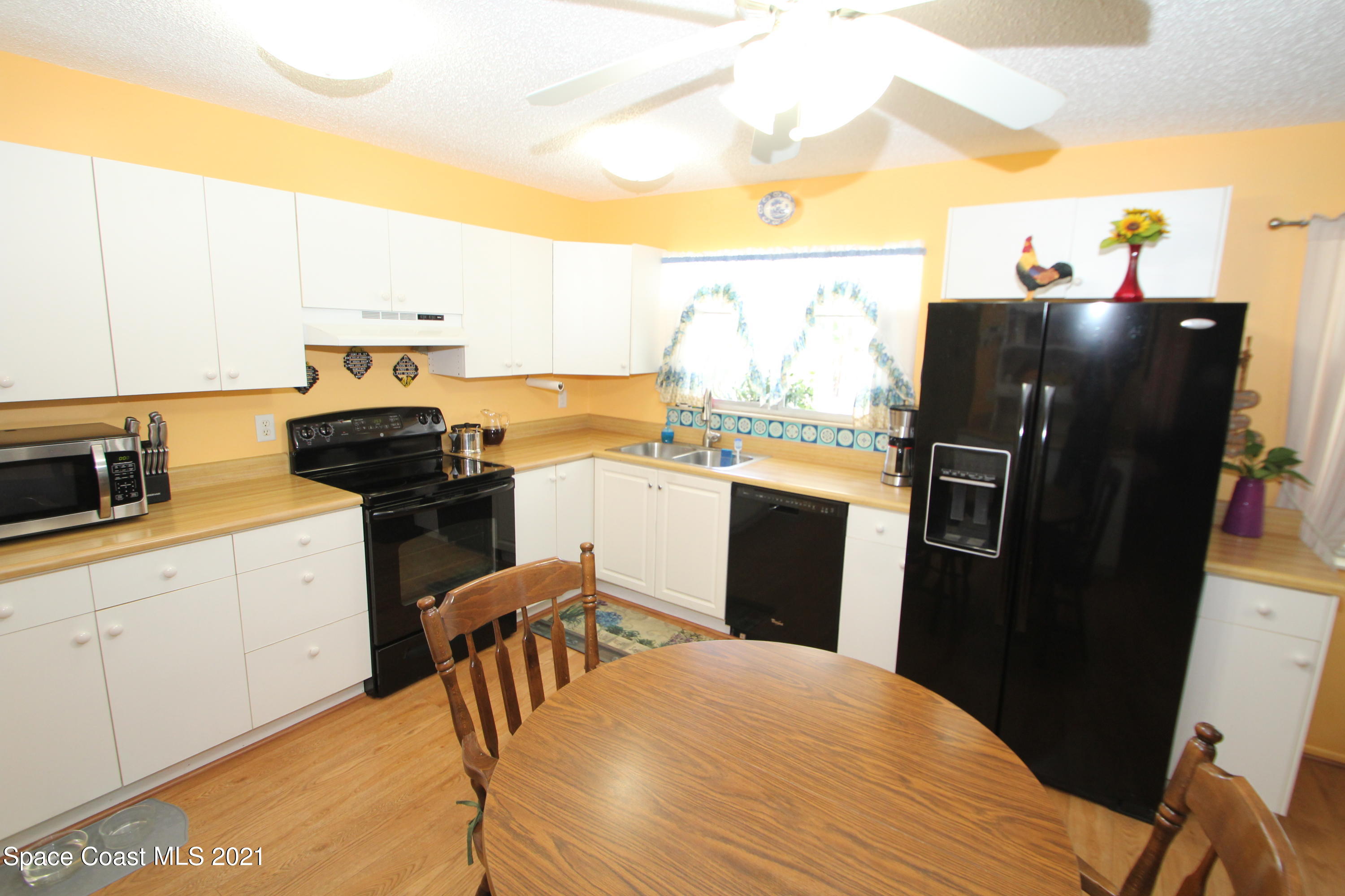 1398 Creel Road Northeast Palm Bay, FL 32905 - Photo 7 of 37 a kitchen with granite countertop a refrigerator stove and sink