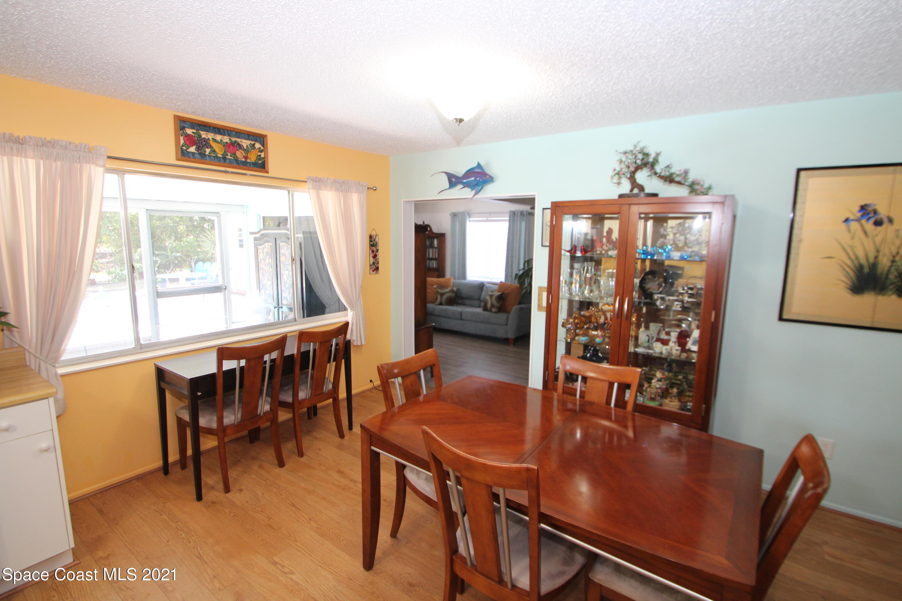 1398 Creel Road Northeast Palm Bay, FL 32905 - Photo 9 of 37 a view of a dining room with furniture and a large window