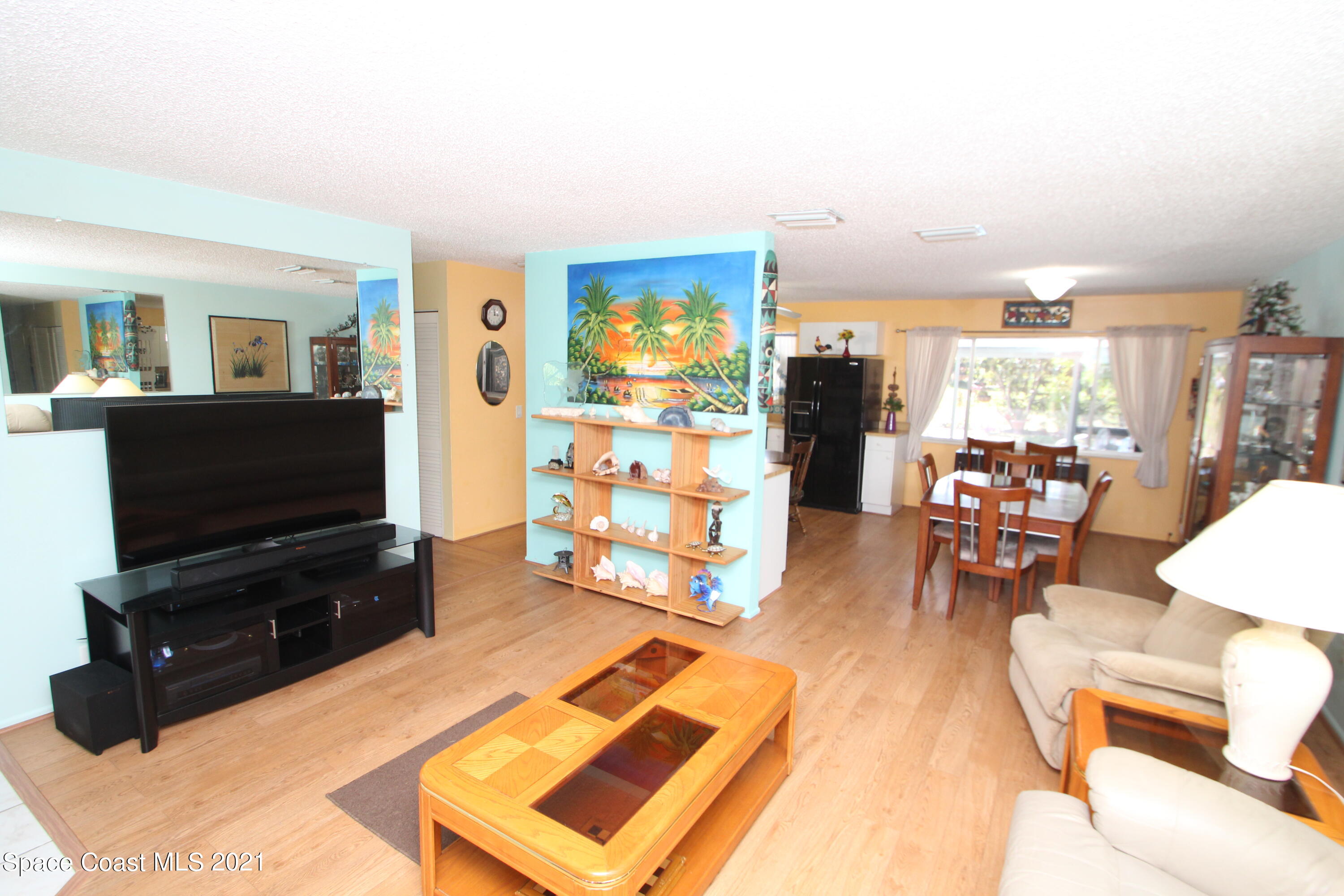 1398 Creel Road Northeast Palm Bay, FL 32905 - Photo 10 of 37 a living room with furniture and a flat screen tv