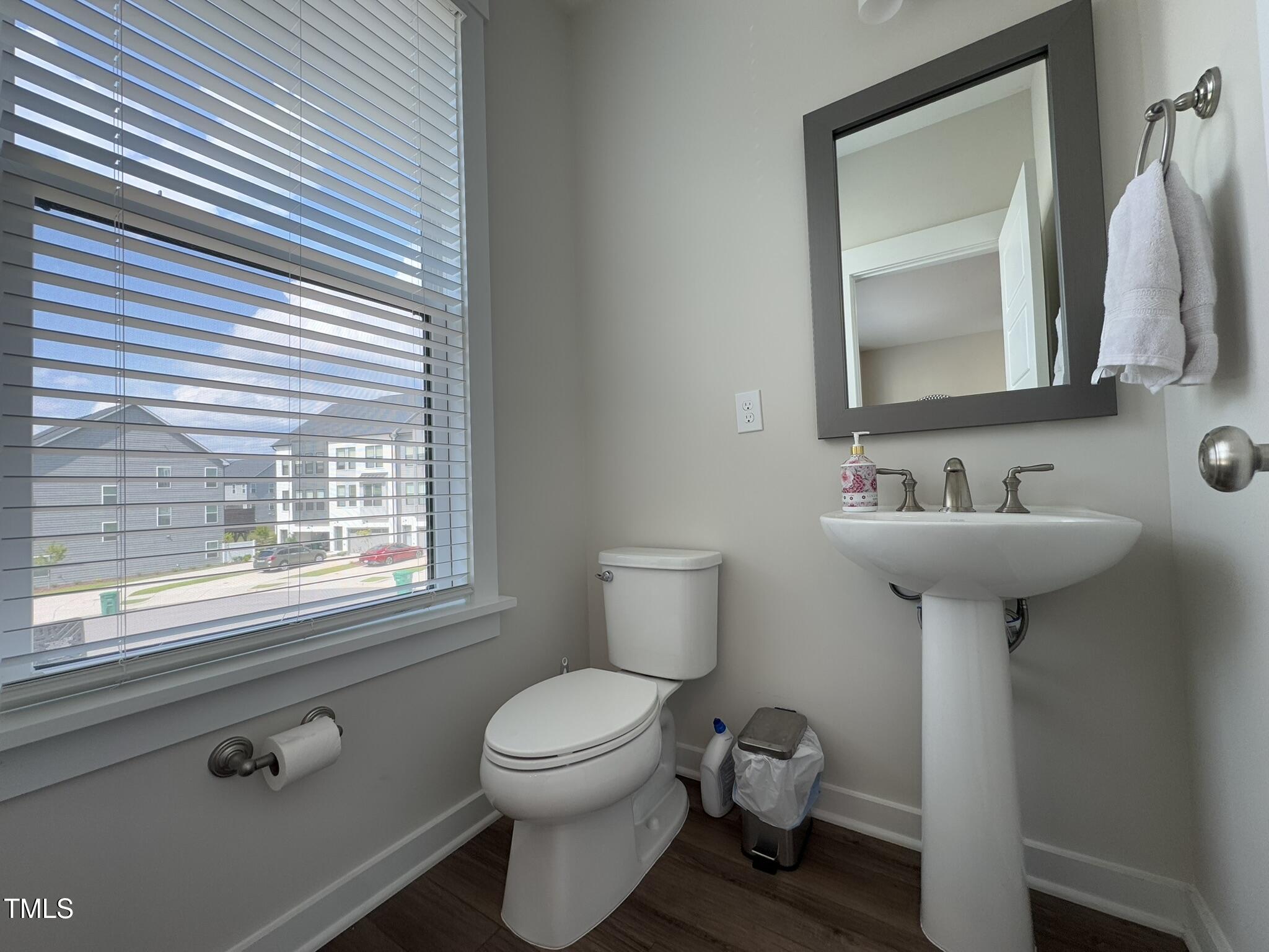 1244 Corkery Ridge Court Cary, NC 27519 - Photo 15 of 37 a bathroom with a toilet sink and mirror
