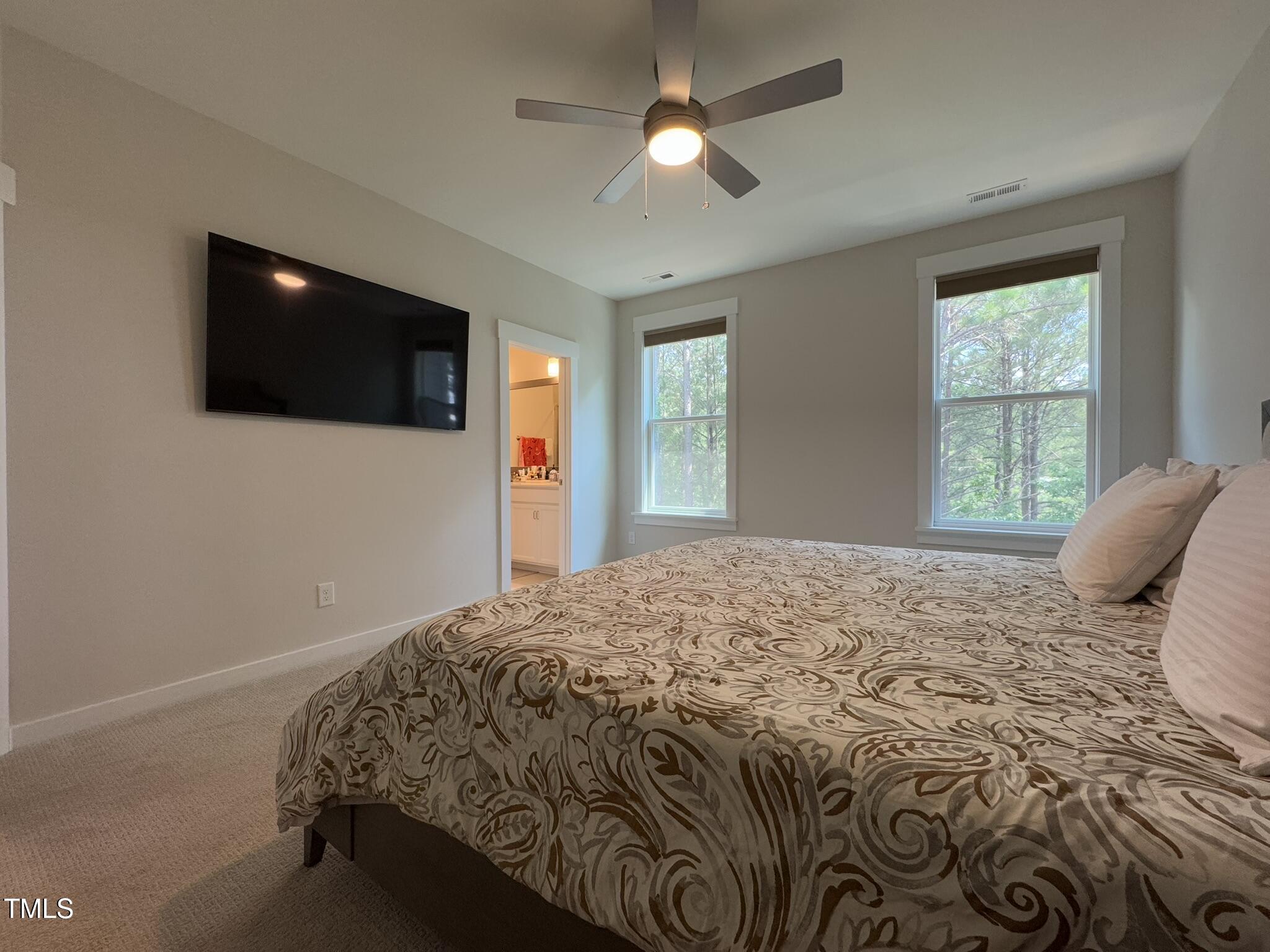 1244 Corkery Ridge Court Cary, NC 27519 - Photo 17 of 37 a bedroom with a large bed and a flat screen tv