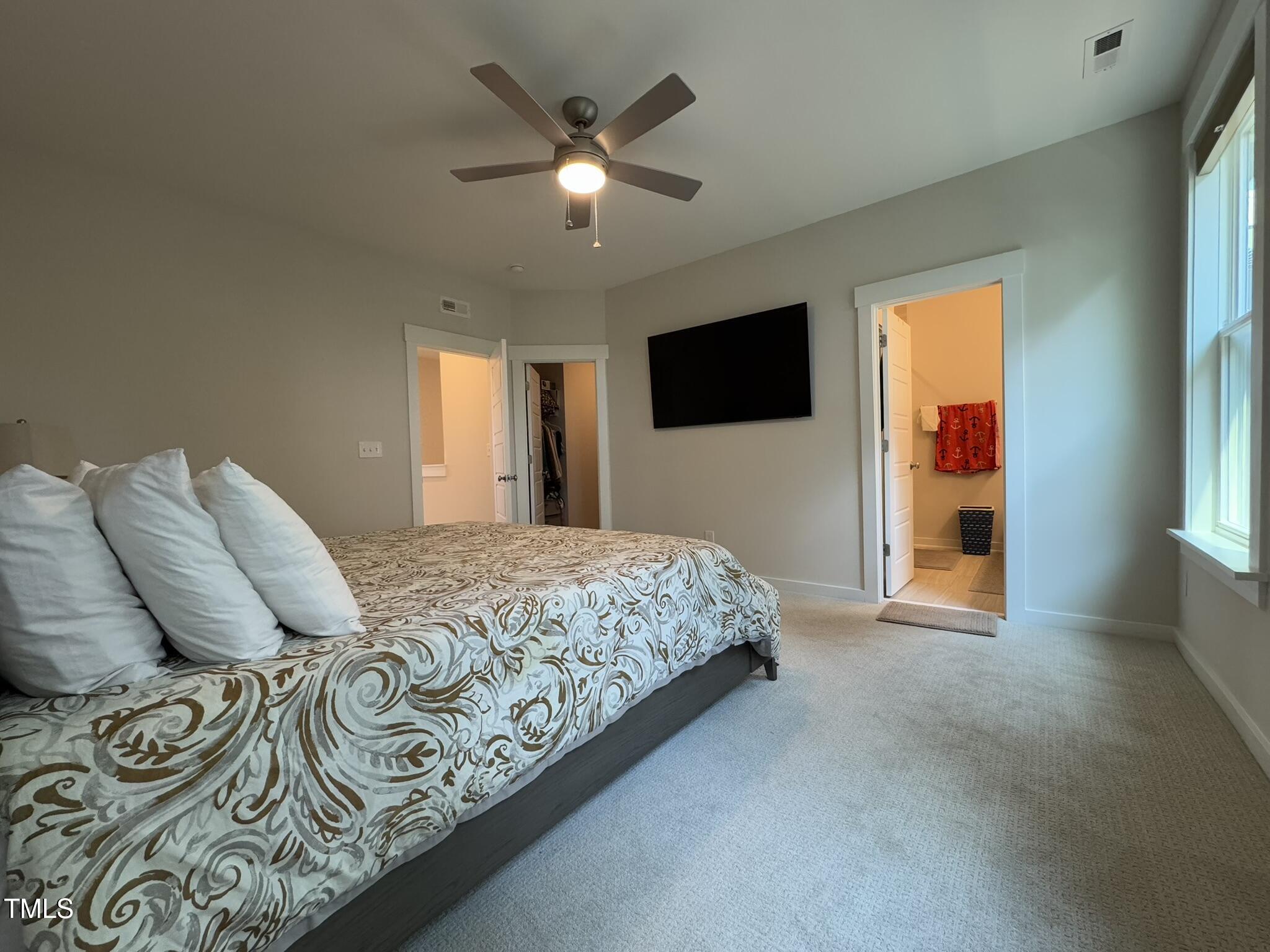 1244 Corkery Ridge Court Cary, NC 27519 - Photo 18 of 37 a bedroom with a large bed and a flat screen tv