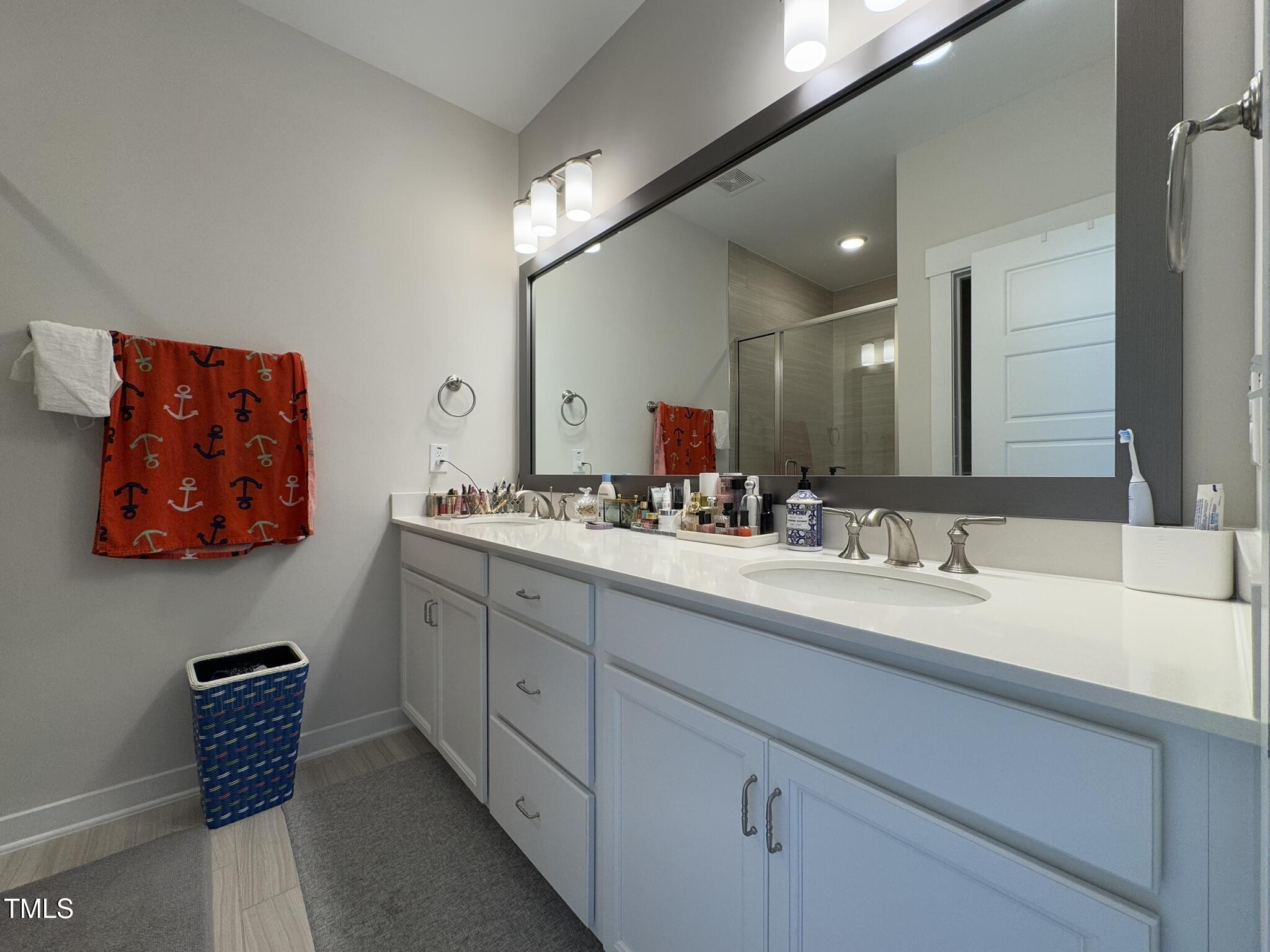 1244 Corkery Ridge Court Cary, NC 27519 - Photo 19 of 37 a bathroom with 2 sink and a mirror
