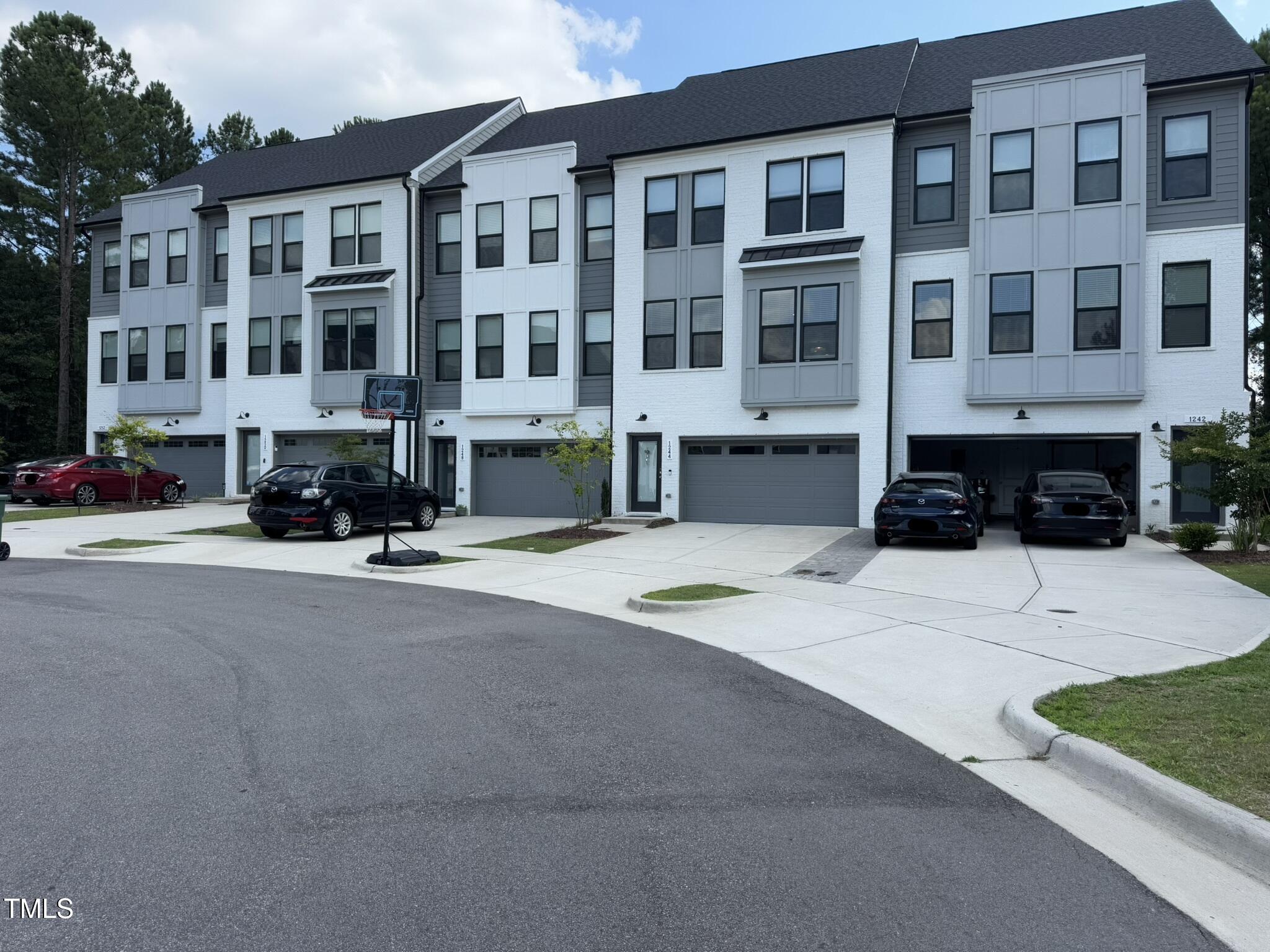 1244 Corkery Ridge Court Cary, NC 27519 - Photo 2 of 37 a front view of a building with street