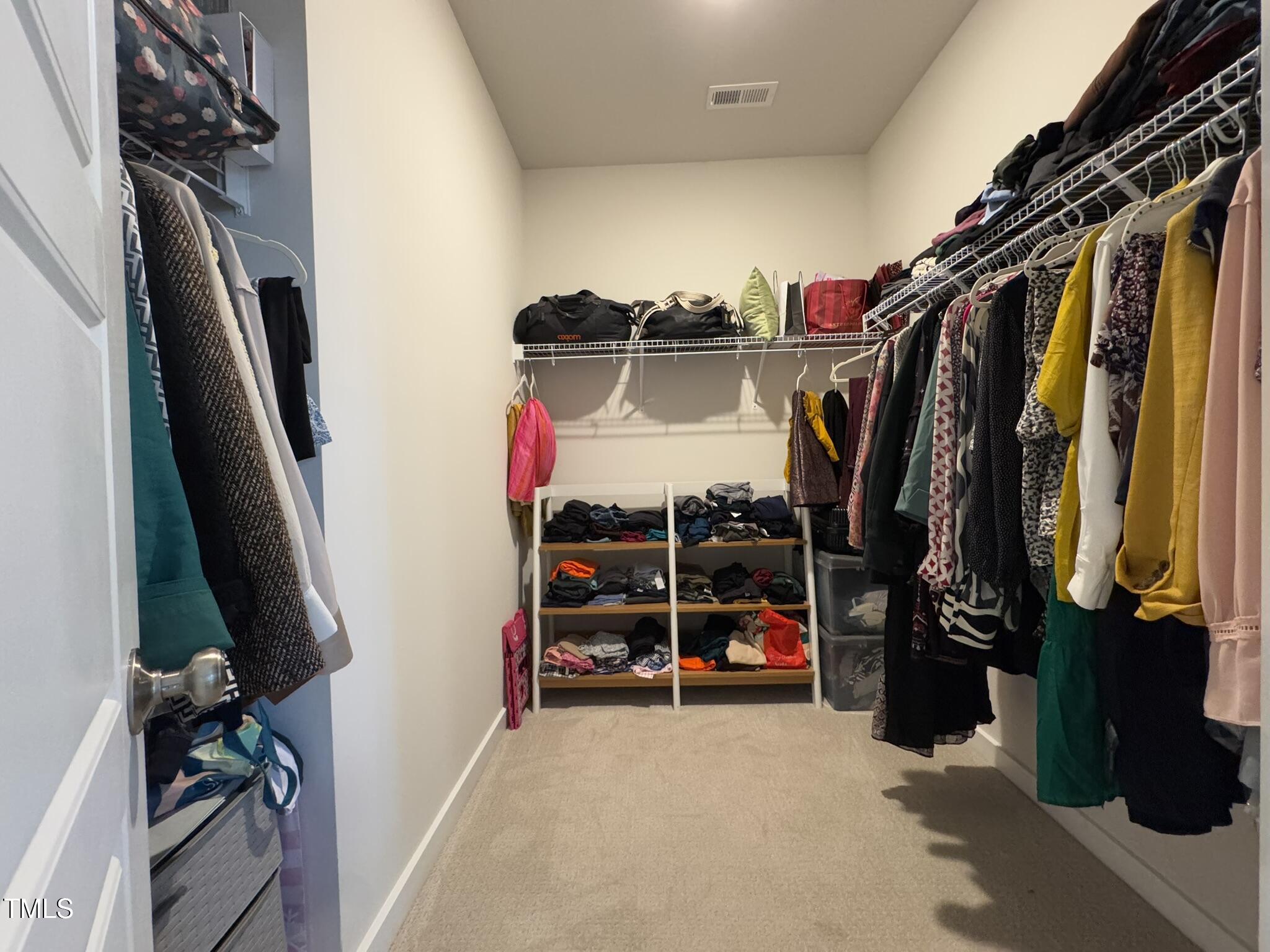 1244 Corkery Ridge Court Cary, NC 27519 - Photo 22 of 37 a view of walk in closet with clothes and shoes