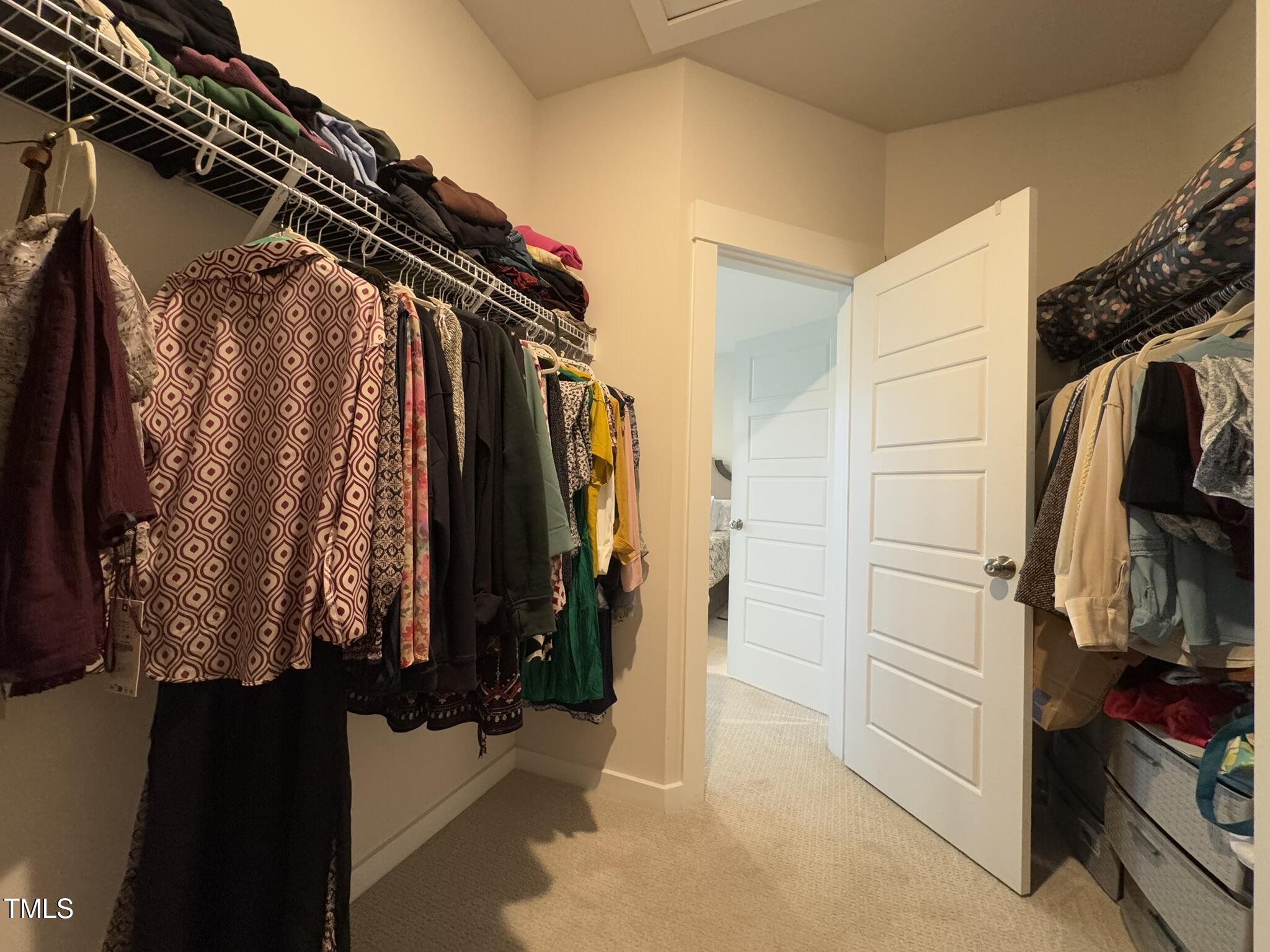 1244 Corkery Ridge Court Cary, NC 27519 - Photo 23 of 37 a view of walk in closet with clothes and shoes