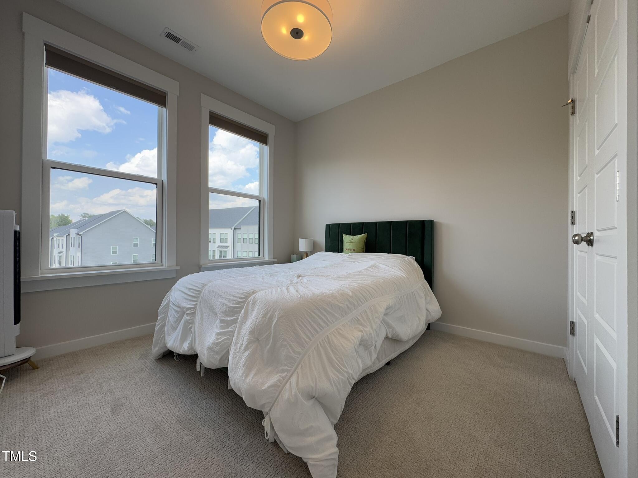 1244 Corkery Ridge Court Cary, NC 27519 - Photo 25 of 37 a bed sitting in a bedroom next to a window