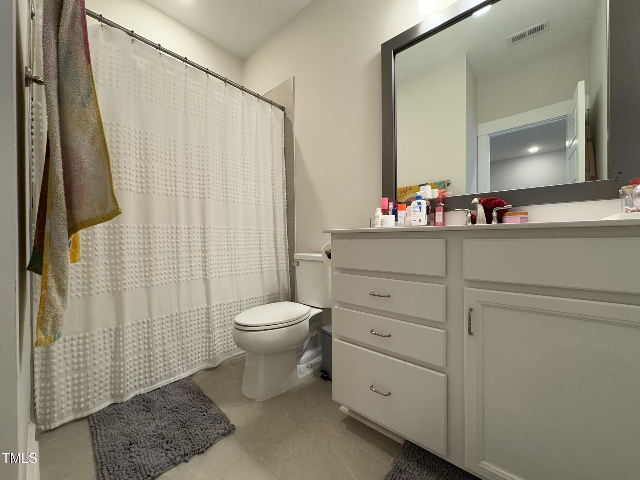 1244 Corkery Ridge Court Cary, NC 27519 - Photo 26 of 37 a bathroom with a toilet a sink and a mirror
