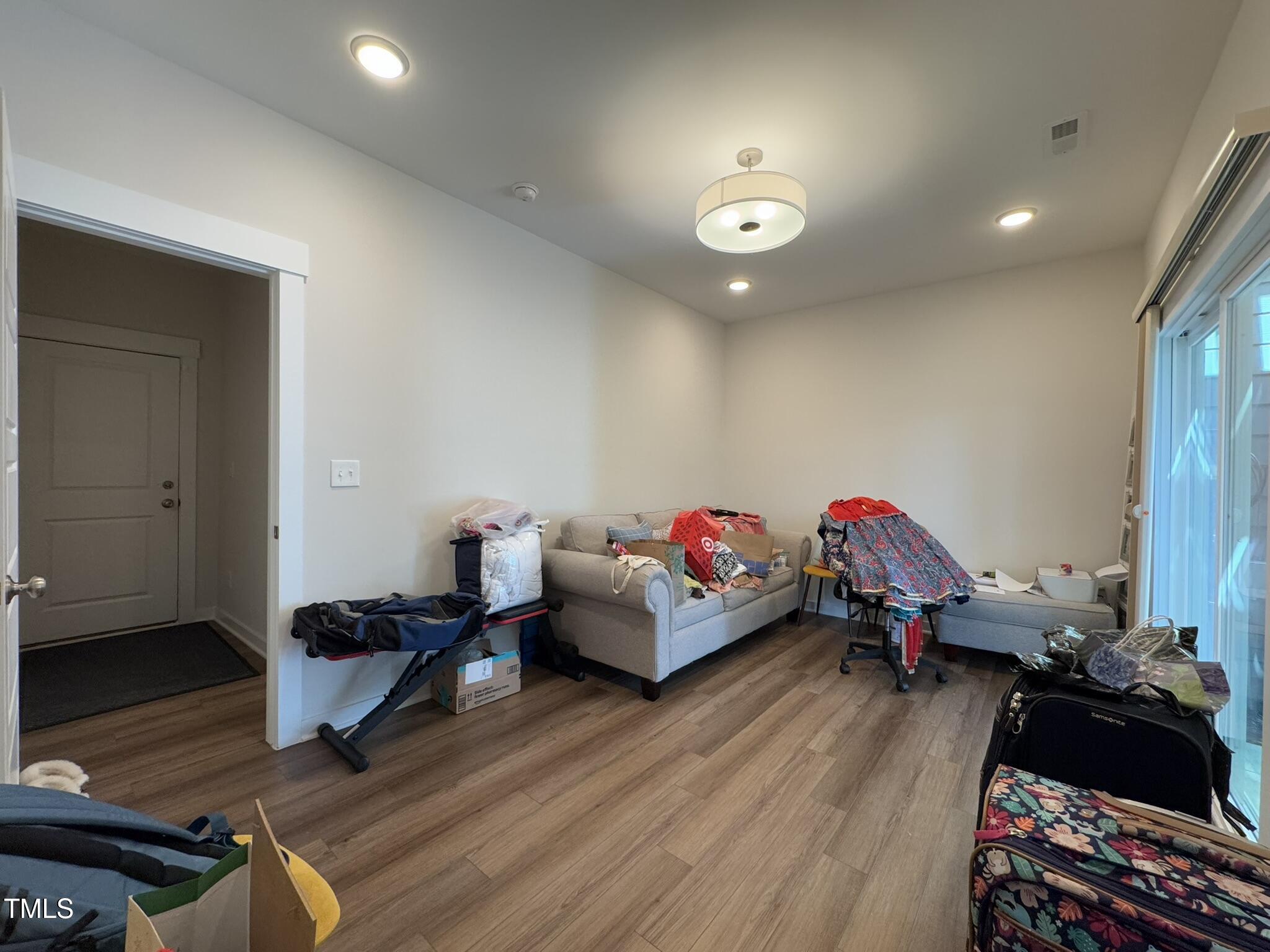1244 Corkery Ridge Court Cary, NC 27519 - Photo 32 of 37 a living room with furniture and a wooden floor