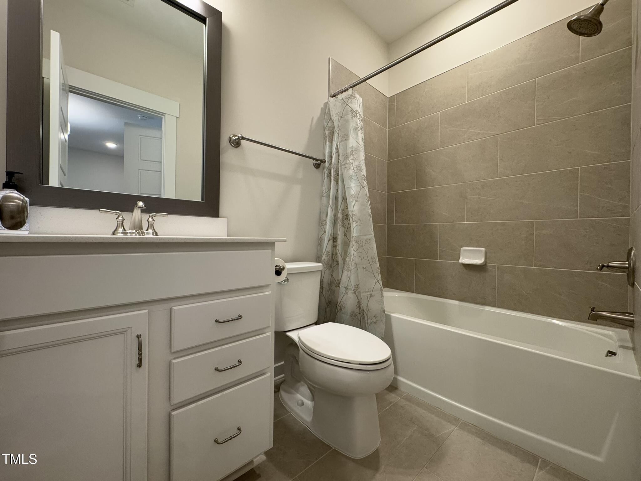 1244 Corkery Ridge Court Cary, NC 27519 - Photo 33 of 37 a bathroom with a sink a toilet and shower