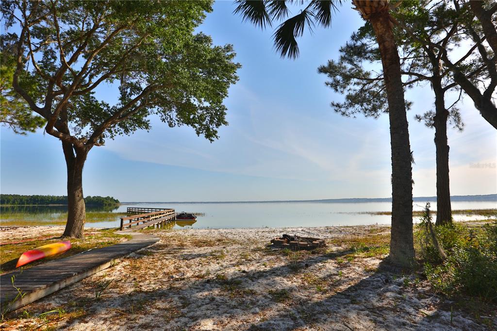 12115 Southeast Sunset Harbor Road Weirsdale, FL 32195 - Photo 15 of 35 a view of a lake with a tree