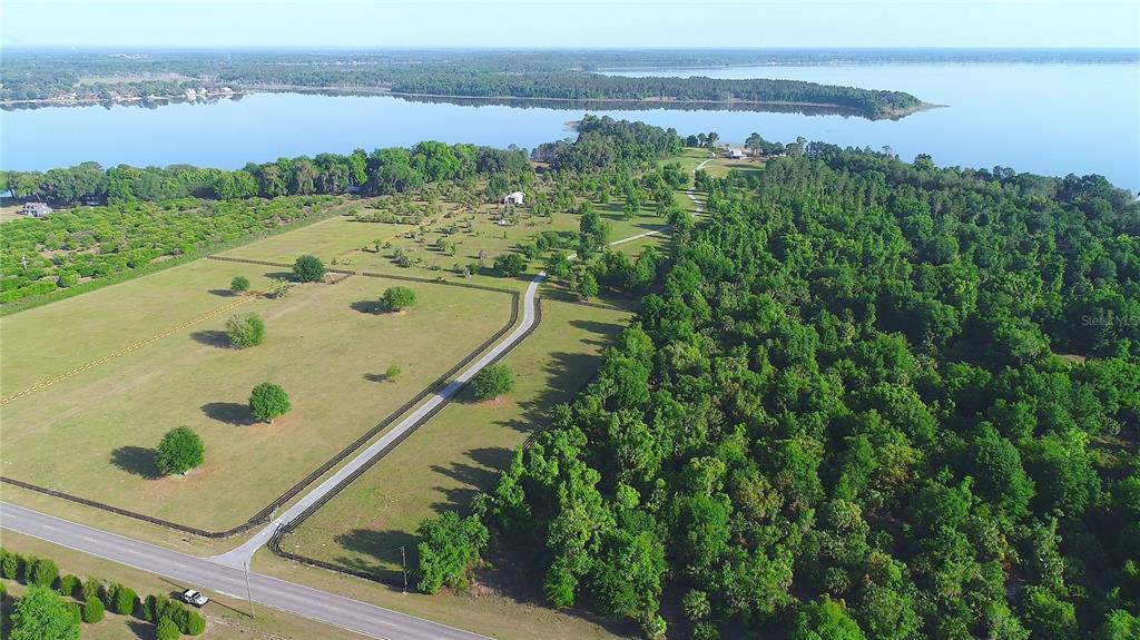 12115 Southeast Sunset Harbor Road Weirsdale, FL 32195 - Photo 19 of 35 an aerial view of a residential houses with outdoor space and street view