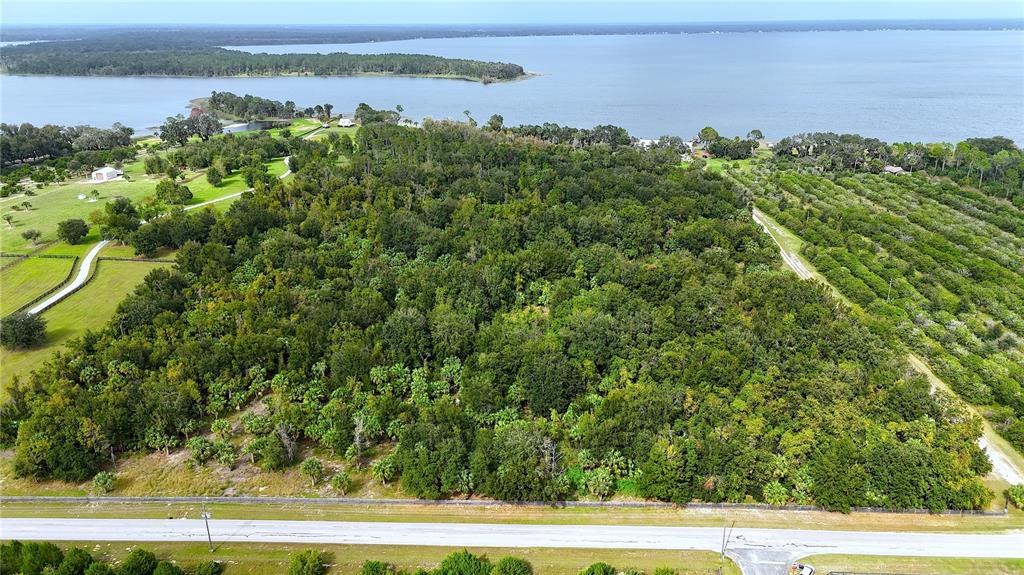 12115 Southeast Sunset Harbor Road Weirsdale, FL 32195 - Photo 20 of 35 a view of a yard with an outdoor space and seating
