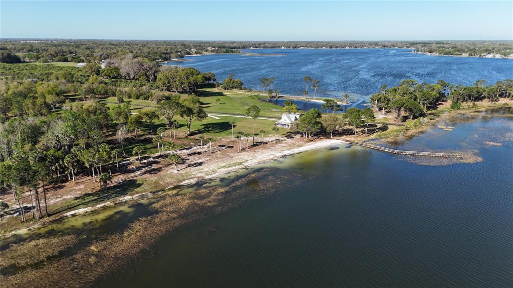 12115 Southeast Sunset Harbor Road Weirsdale, FL 32195 - Photo 3 of 35 an aerial view of a house with a yard