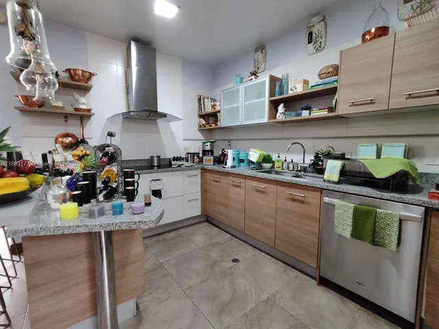a kitchen with lots of clutter and cabinets