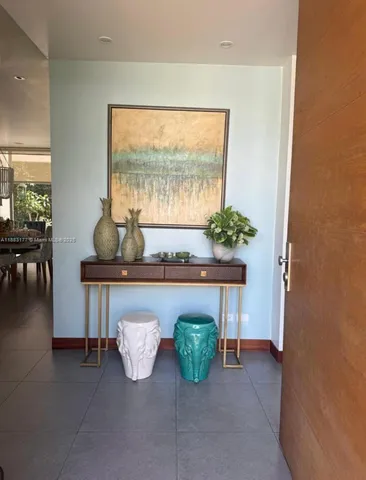 a dining room with furniture and a floor to ceiling window