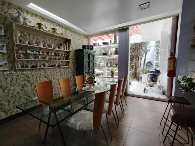 a hallway with painting and a potted plant
