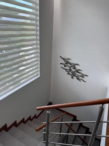 a view of room with window and wooden floor