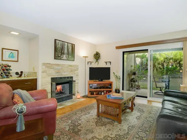 a living room with furniture fireplace and a flat screen tv