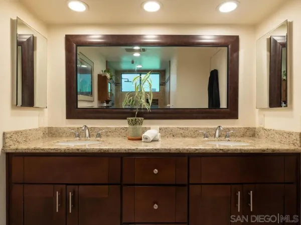 a bathroom with a double vanity sink and a mirror