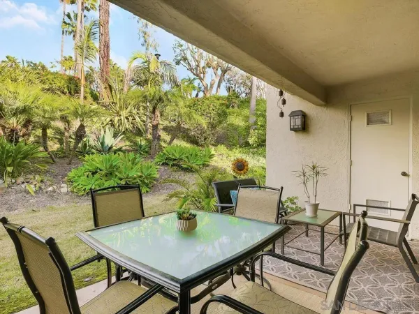 a view of a chairs and table in the patio