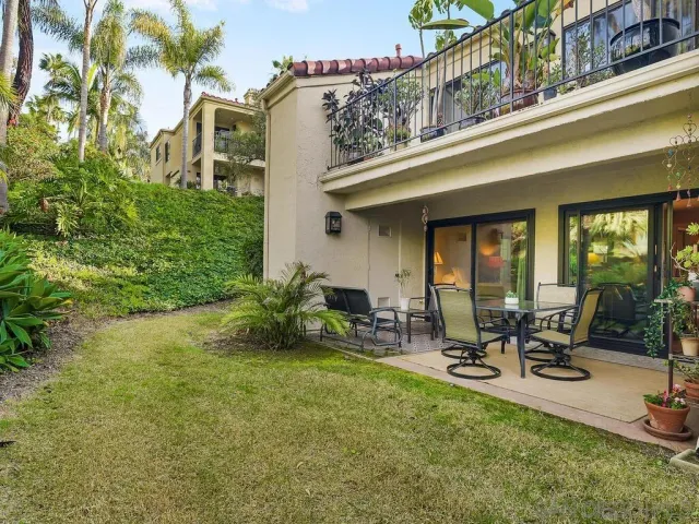 a view of a patio with table and chairs and plants