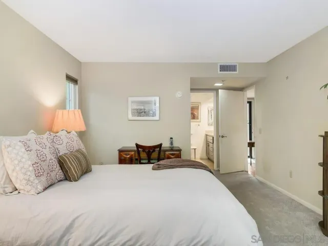 a bedroom with a bed and a lamp