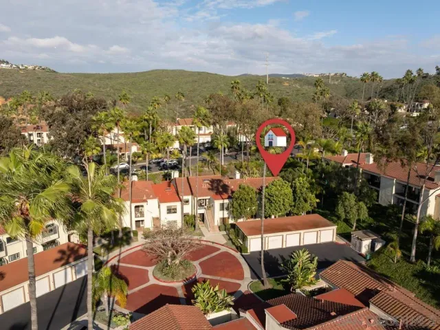 an aerial view of a house with a yard and outdoor seating