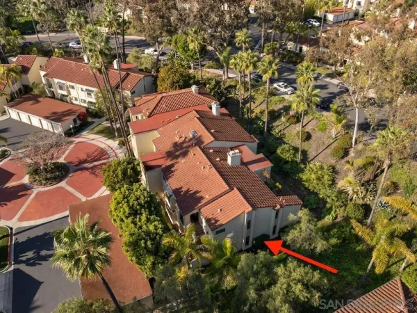 an aerial view of a house with a yard and outdoor seating