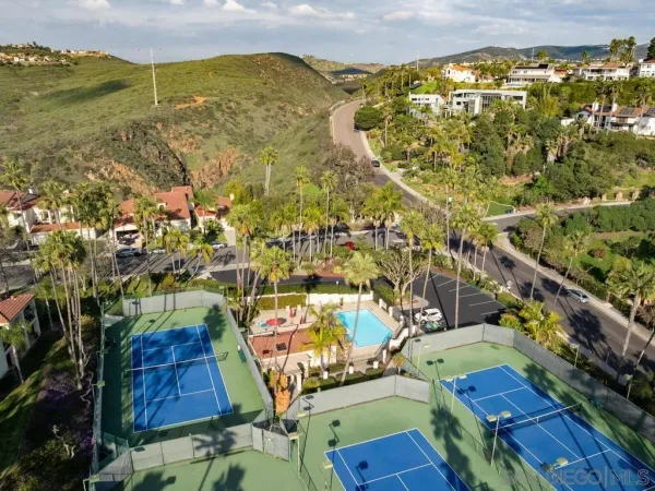an aerial view of residential houses with outdoor space
