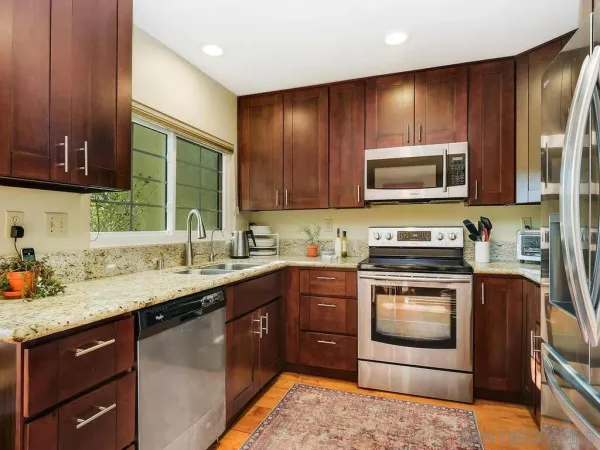 a kitchen with a sink stove and microwave