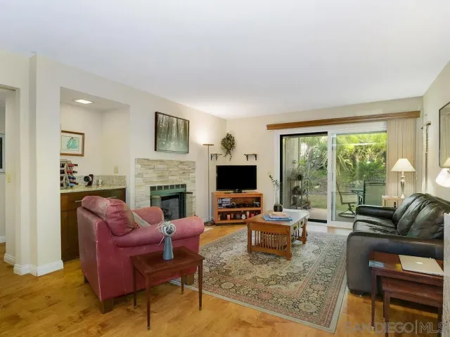 a living room with furniture large windows and a flat screen tv