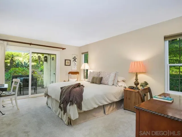 a bedroom with a bed and a lamp next to a window