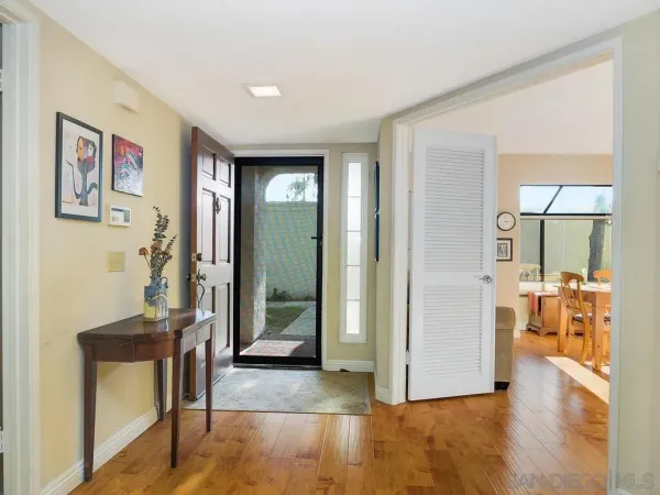 a view of a livingroom with wooden floor and a flat screen tv