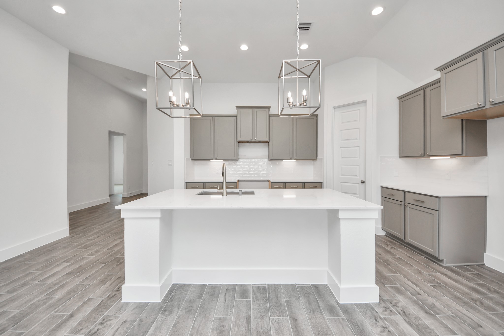 3046 Native Spg Drive Spring, TX 77373 - Photo 11 of 35 This kitchen is by far any chef’s dream! This spacious kitchen features high ceilings, light stained wood cabinets, granite countertop, SS appliances, modern tile backsplash, recessed lighting, extended counter space, granite kitchen island, and space for breakfast bar, and a walk-in pantry all overlooking your huge family room. Sample photo of completed home with similar floor plan. Actual colors and selections may vary.