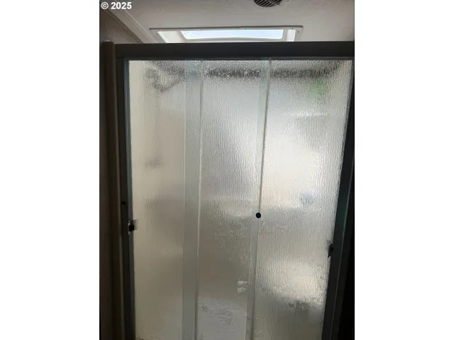 a bathroom with a glass shower door